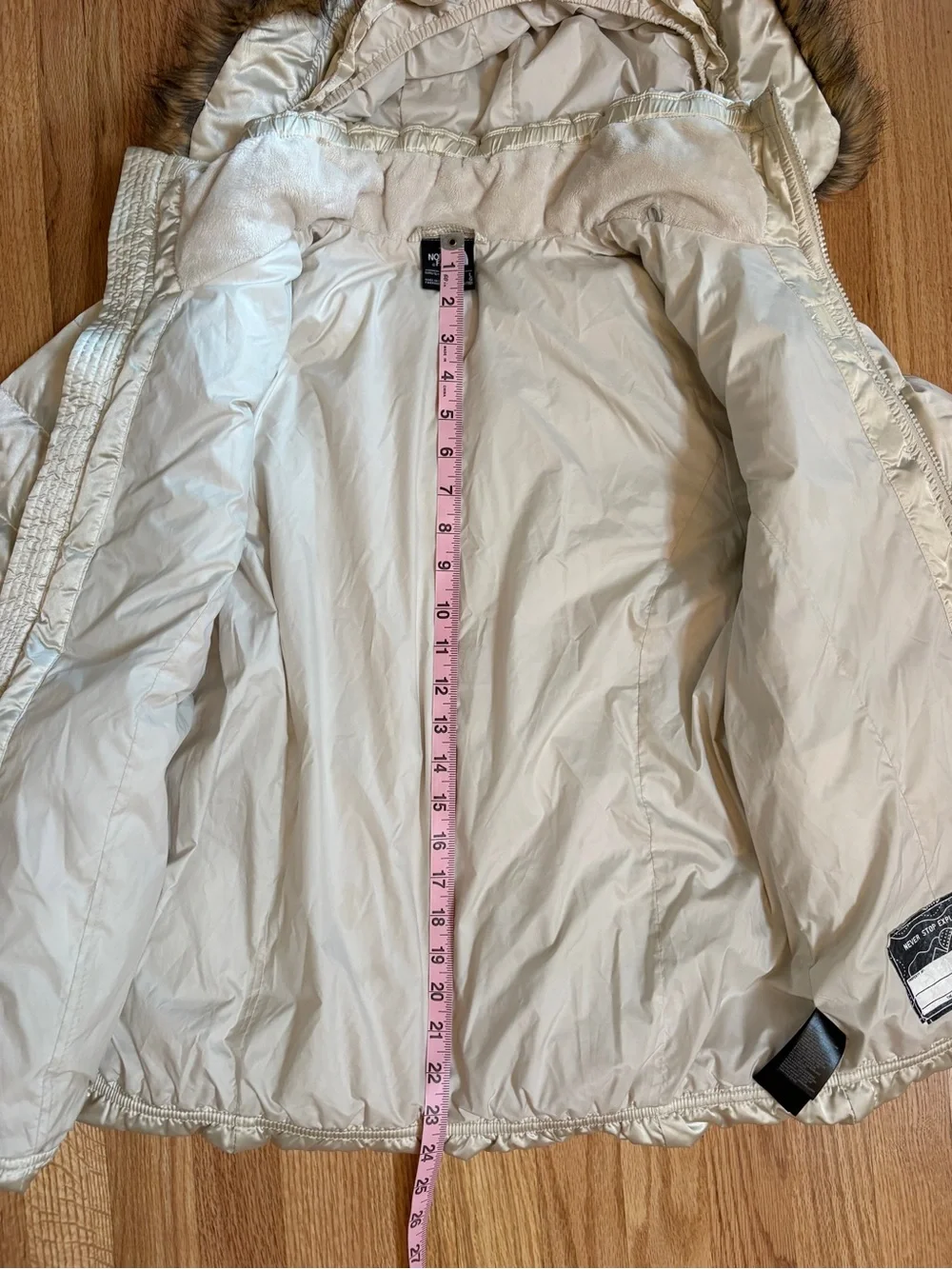 The North Face Girls champagne-colored puffer jacket